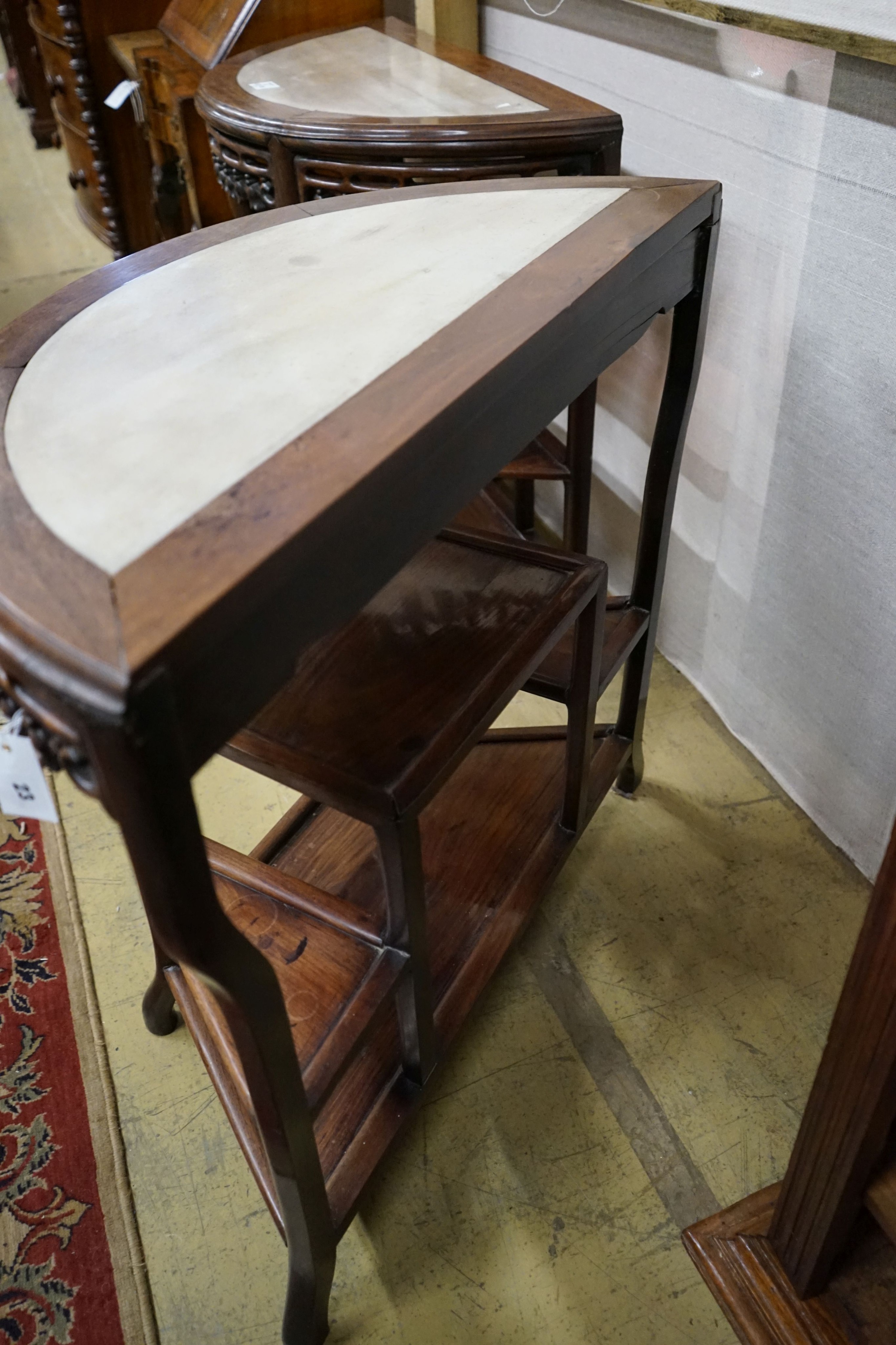 A pair of Chinese marble-topped demi lune console tables, width 82cm, depth 40cm, height 80cm